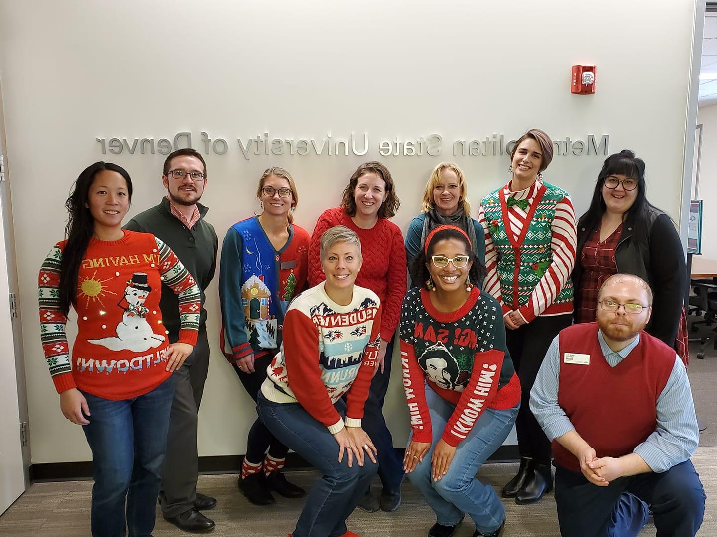 group photo with employees dressed in holiday sweaters