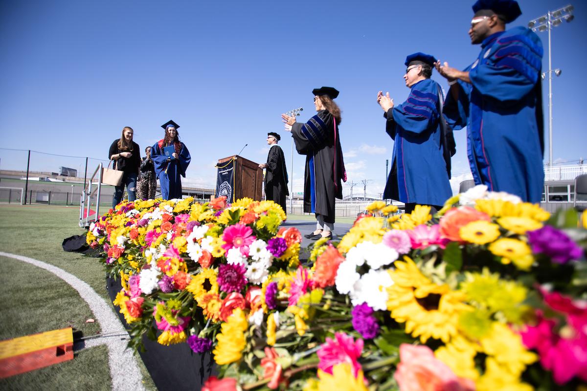 MSU Denver student walking across the stage at Spring 2021 Commencement