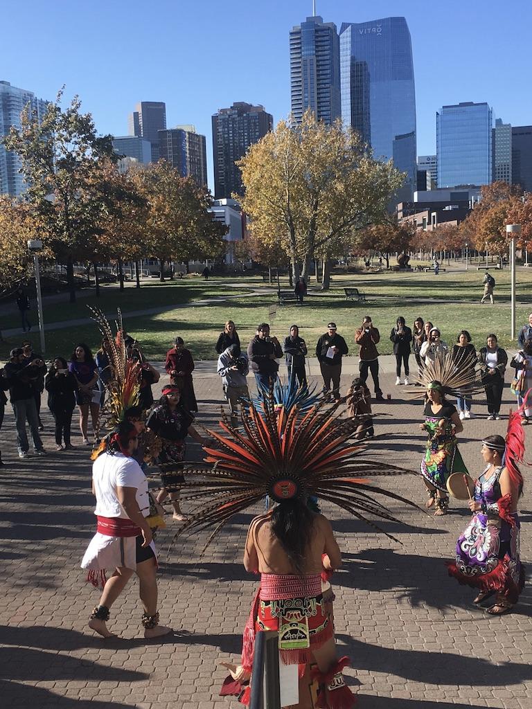 Aztec dancers outside on campus