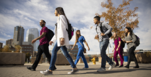 Six students walk across campus.