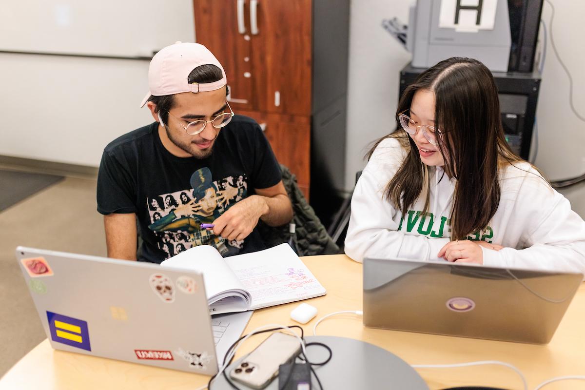 Metropolitan State University of Denver students collaborating at a desk.